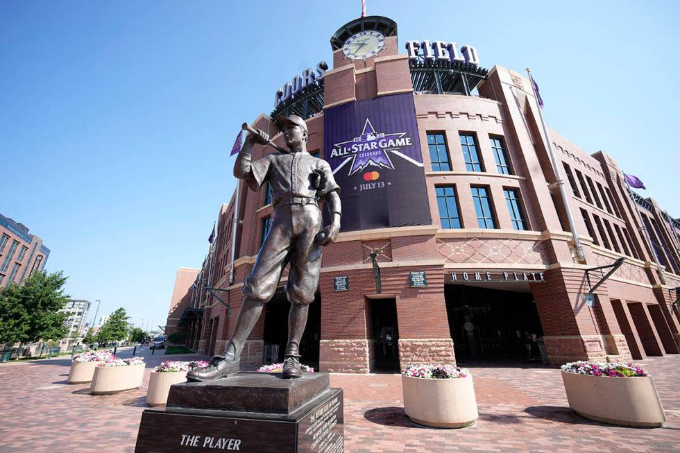 A All Star Game banner hangs from the front entrance of Coors Field behind a sculpture named &q ...
