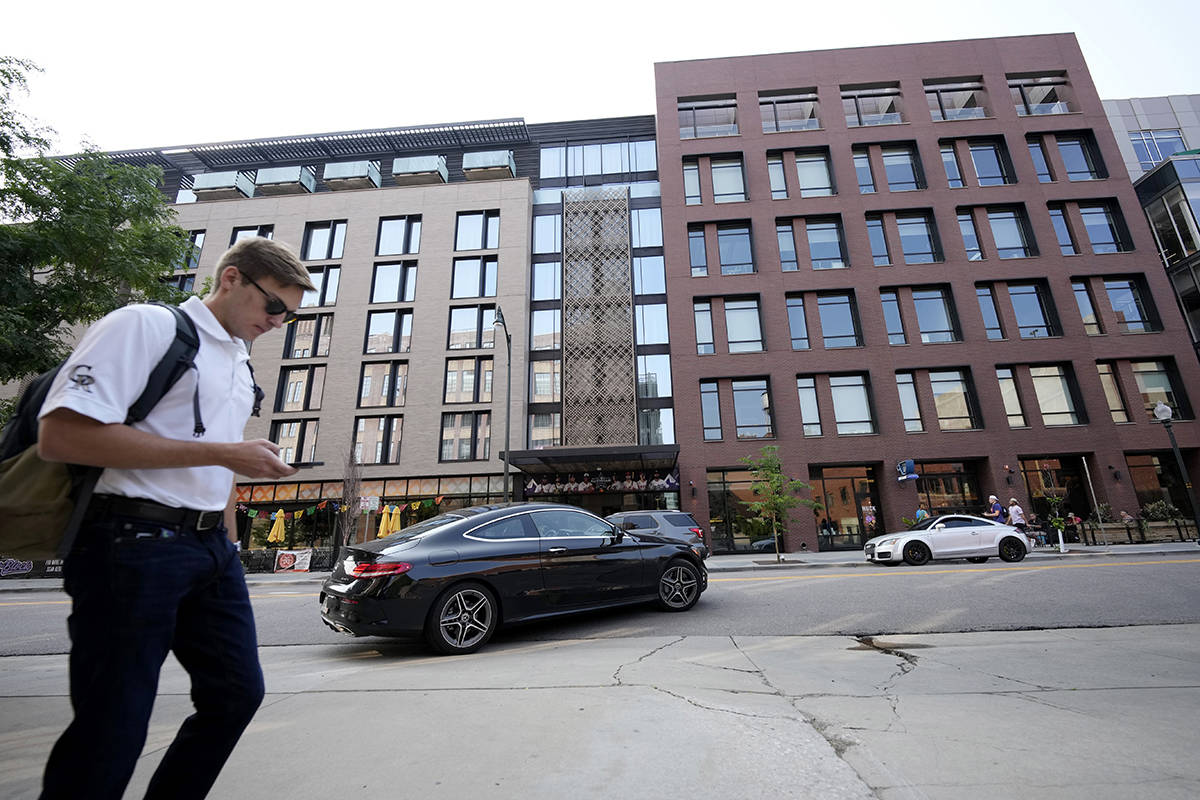 A pedestrian moves past the Maven Hotel Sunday, July 11, 2021, in lower downtown Denver. Author ...