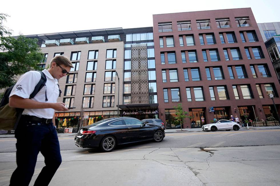 A pedestrian moves past the Maven Hotel Sunday, July 11, 2021, in lower downtown Denver. Author ...