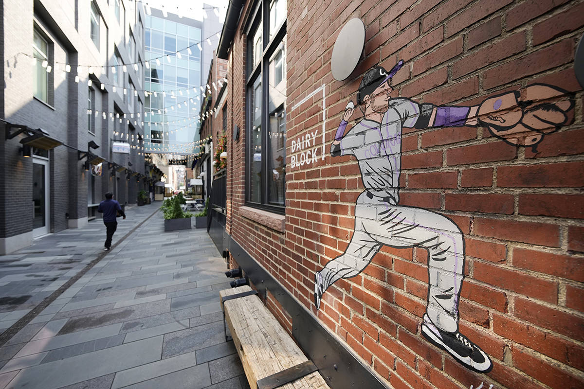 A mural adorns a wall in the alleyway in the Dairy Block leading to the Maven Hotel Sunday, Jul ...