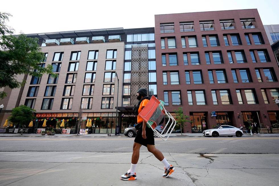 A man walks past the Maven Hotel Sunday, July 11, 2021, in lower downtown Denver. Authorities s ...