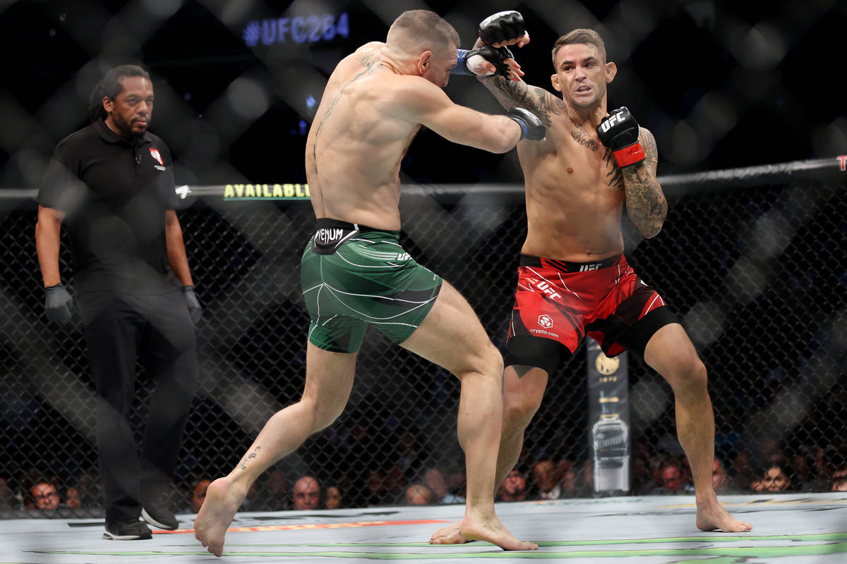 Conor McGregor, left, and Dustin Poirier, battles in the first round of a lightweight bout agai ...