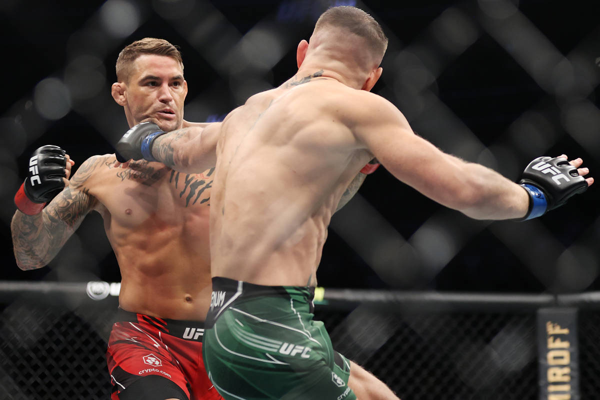 Conor McGregor, right, connects a punch against Dustin Poirier in the first round of a lightwei ...