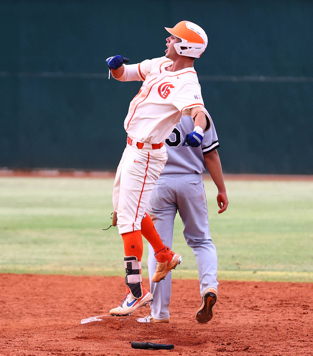 Bishop Gorman HighÕs right fielder Tyler Whitaker celebrates after hitting a double and 2r ...