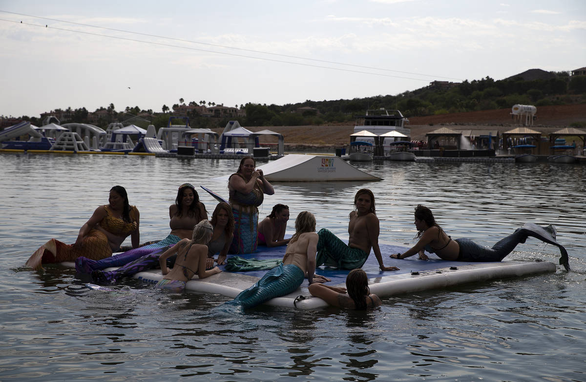 Mermaids sun themselves at Lake Las Vegas on Saturday, June 19, 2021, in Henderson. (Ellen Schm ...