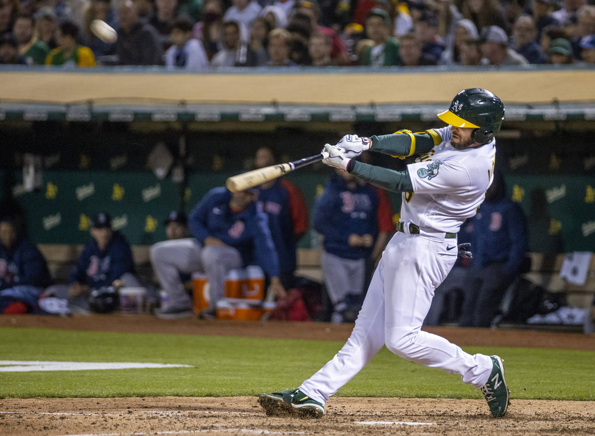 The Oakland A‘s infielder Jed Lowrie (8) hits a home run against the Boston Red Sox at RingCe ...