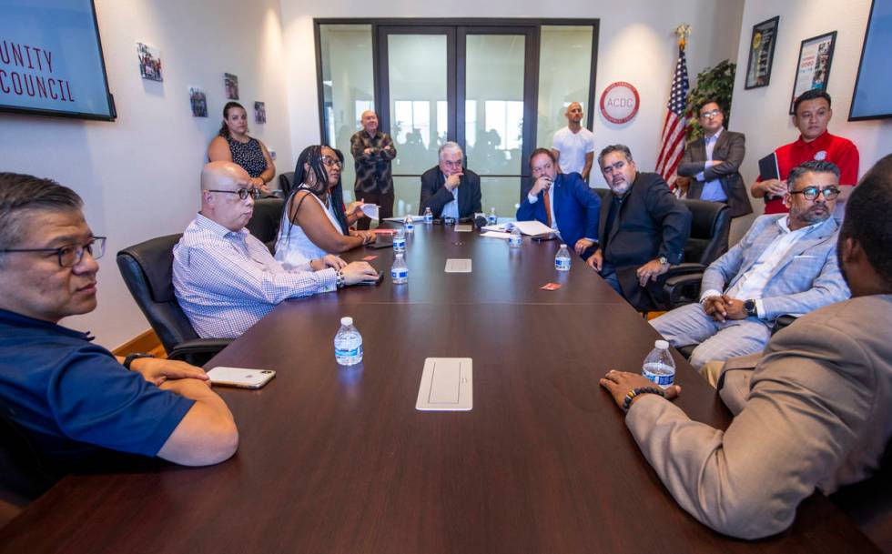 Governor Steve Sisolak, center, and Treasurer Zach Conine, center right, take questions as they ...