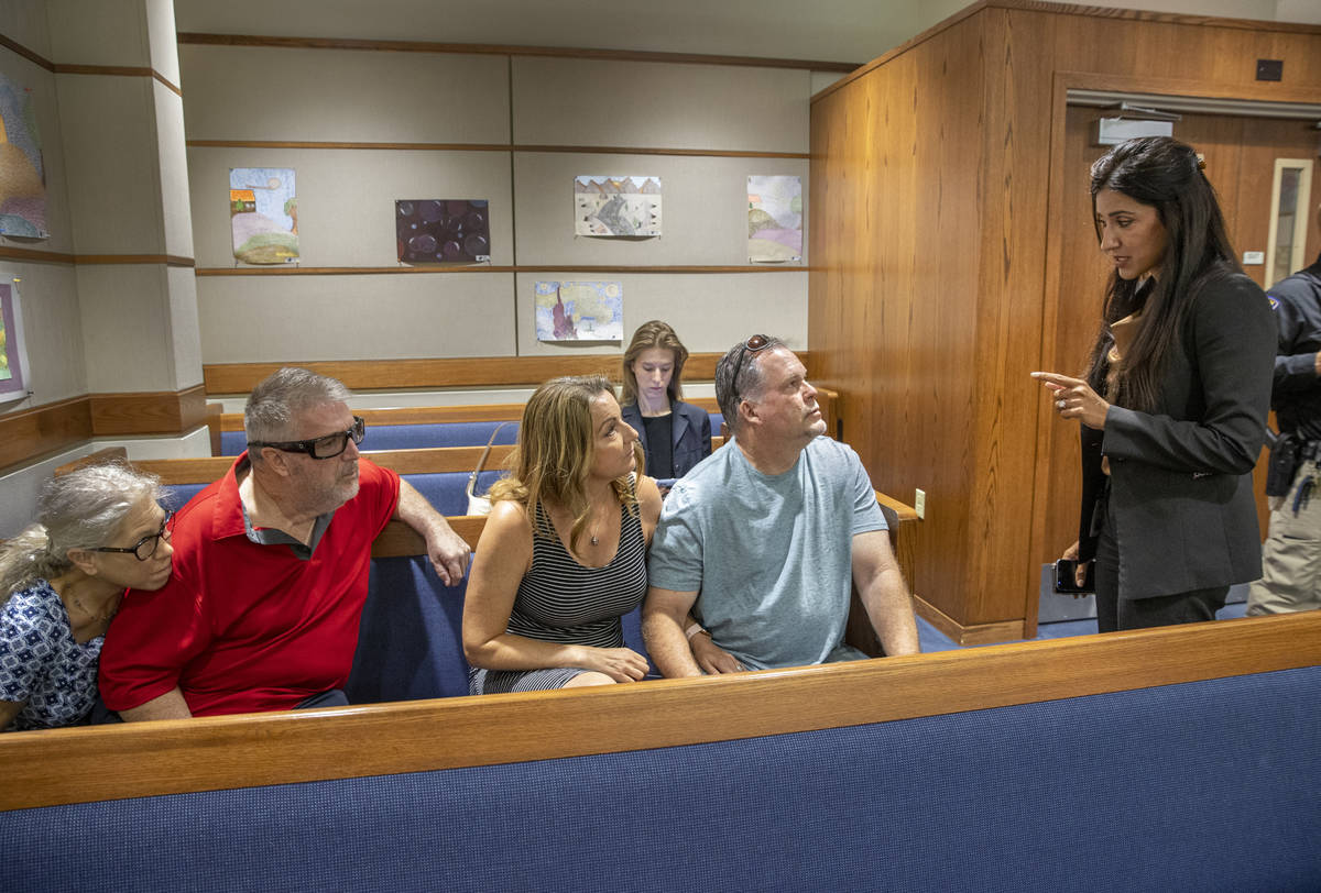 (From right) Chief Deputy District Attorney Tina Talim speaks to parents Marty and Tami Slatsky ...