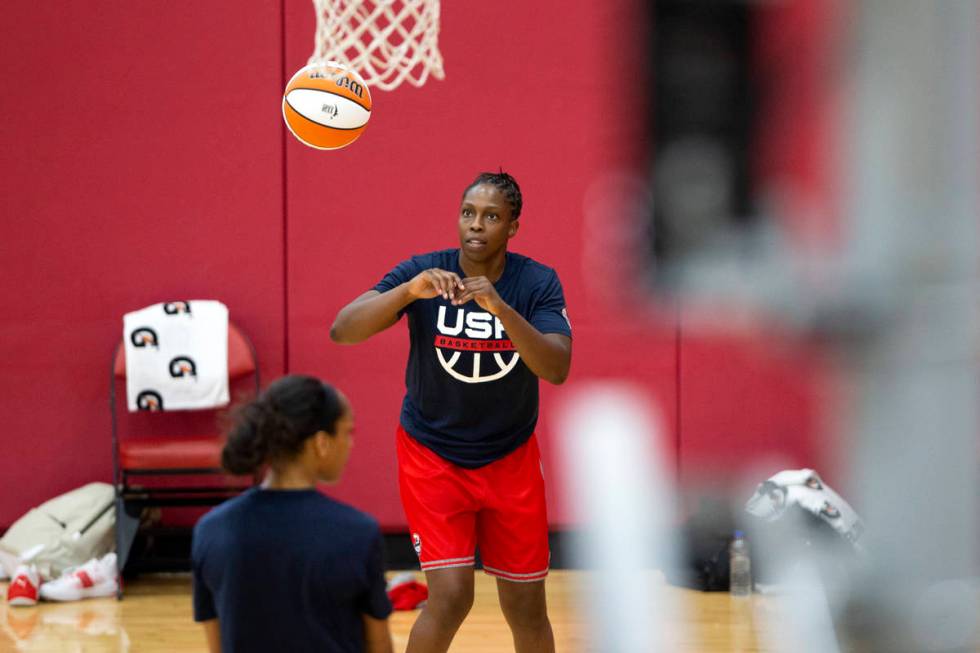 Chelsea Gray, center, practices with her teammate A'ja Wilson, left, during a 2021 USA Basketba ...