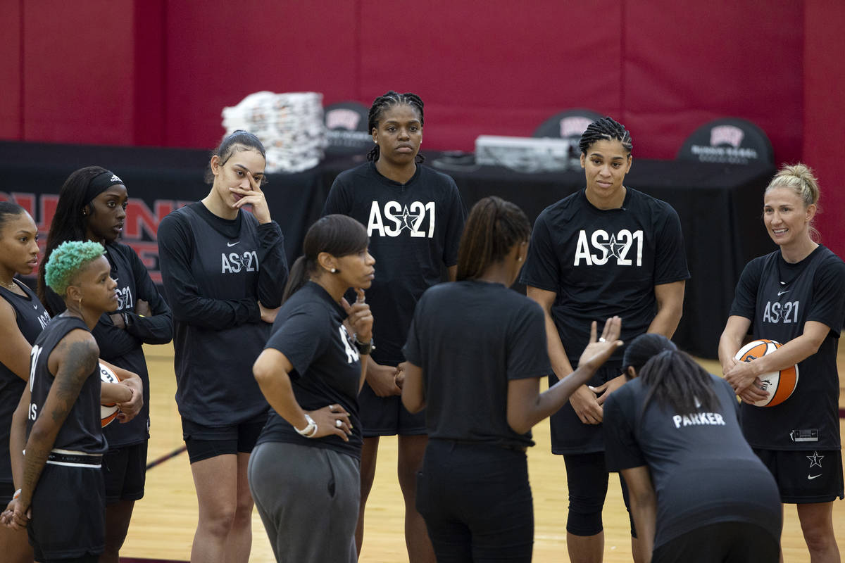 Co-head coaches Tina Thompson, center left, and Lisa Leslie, center right, gather the team duri ...