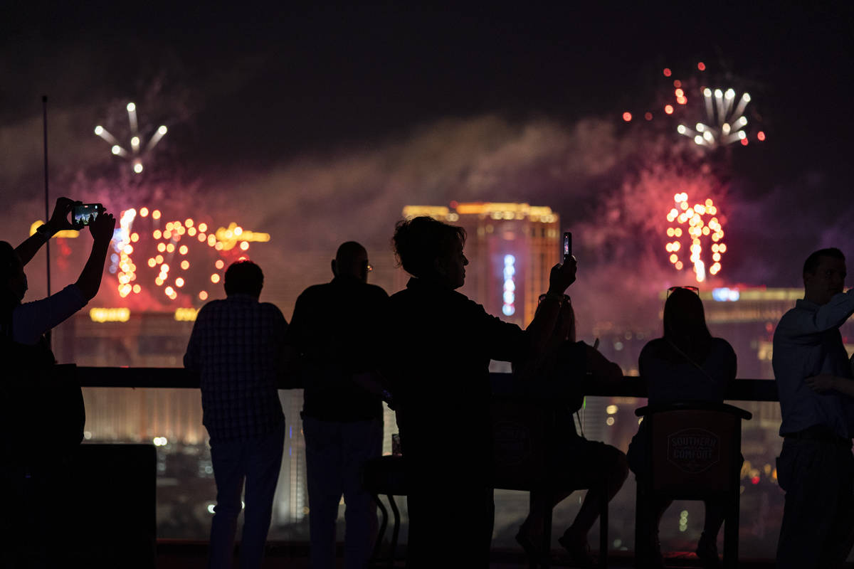 Spectators watch as fireworks explode over the Las Vegas Strip during a 4th of July Fireworks s ...