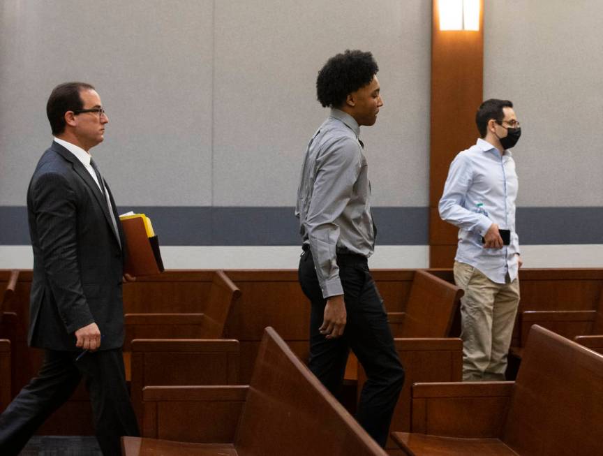 Former Bishop Gorman High School basketball standout Zaon Collins, center, and his attorney Ric ...