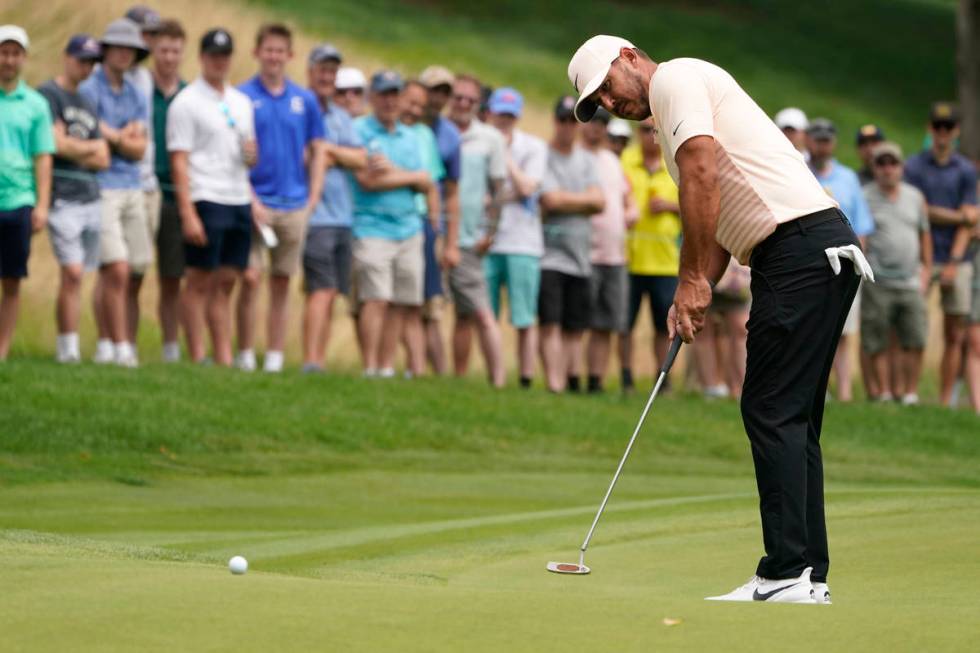 Brooks Koepka watches his putt on the first hole during the final round of the Travelers Champi ...