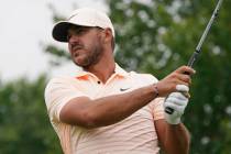 Brooks Koepka watches his tee shot on the second tee during the final round of the Travelers Ch ...