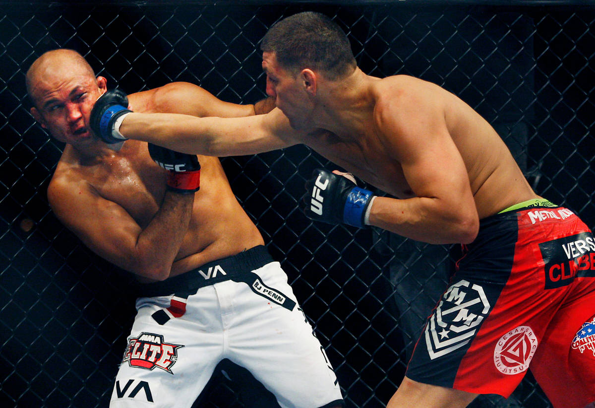 Nick Diaz, right, lands a right hand to the face of BJ Penn during the main event at UFC 137 at ...