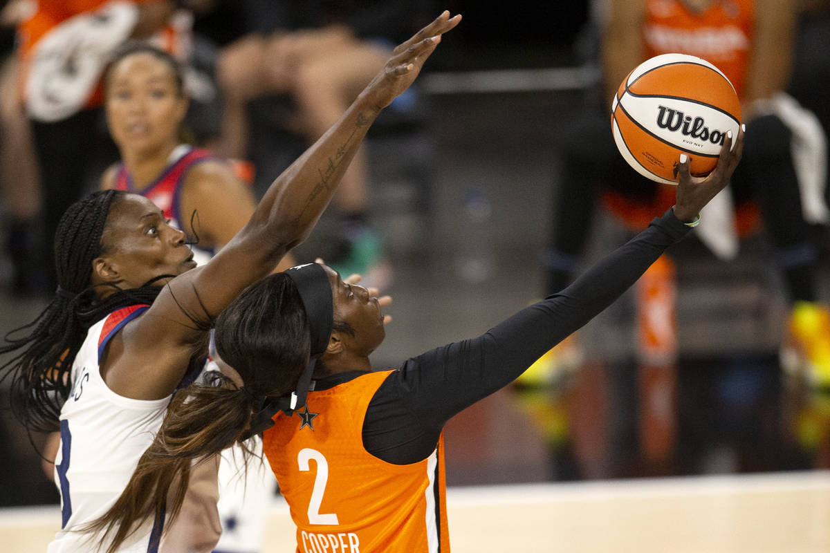 U.S. Women's National Team's Sylia Fowles (13), left, attempts to block a shot by Team WNBA's K ...