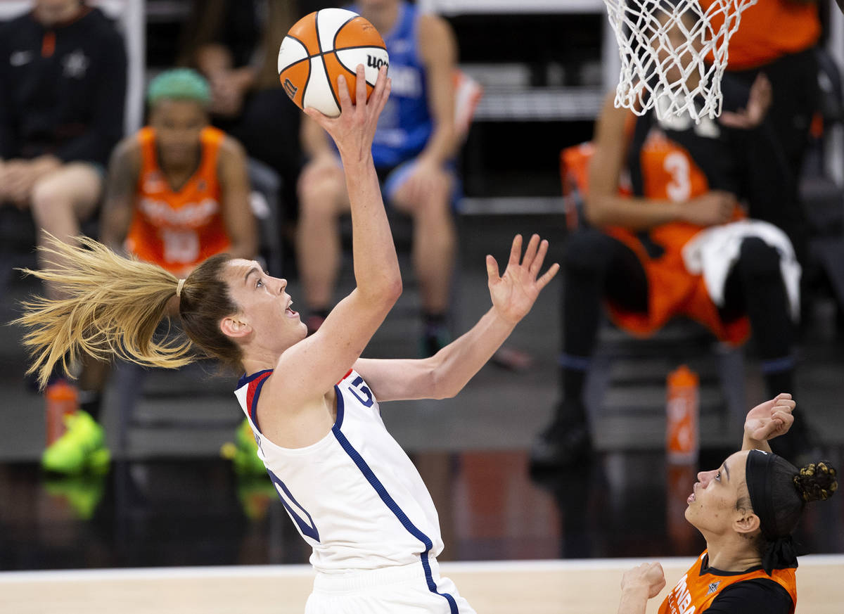 U.S. Women's National Team's Breanna Stewart, left, jumps for a shot while Team WNBA's Dearica ...