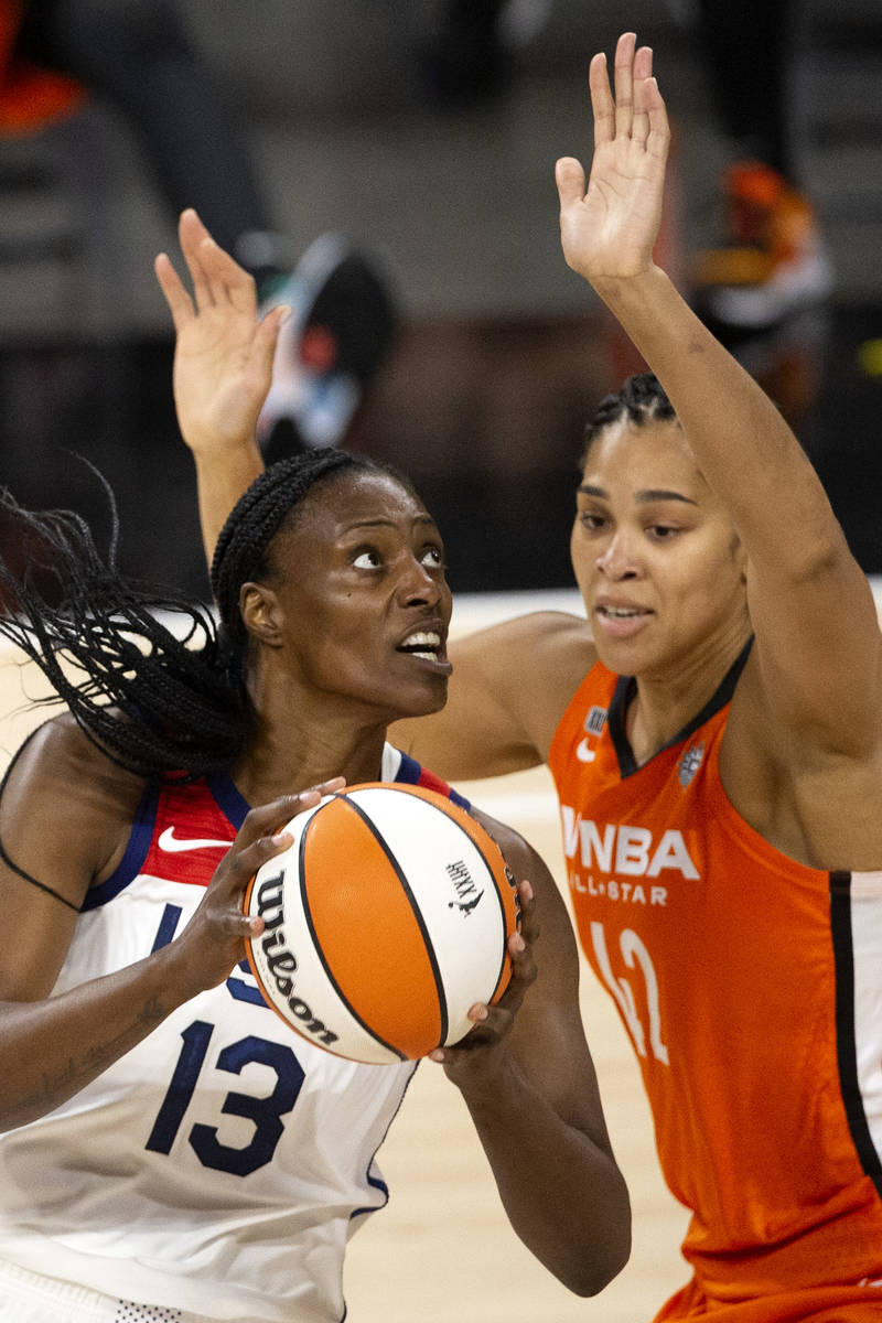 U.S. Women's National Team's Sylvia Fowles (13) goes up for a layup guarded by Team WNBA's Brio ...