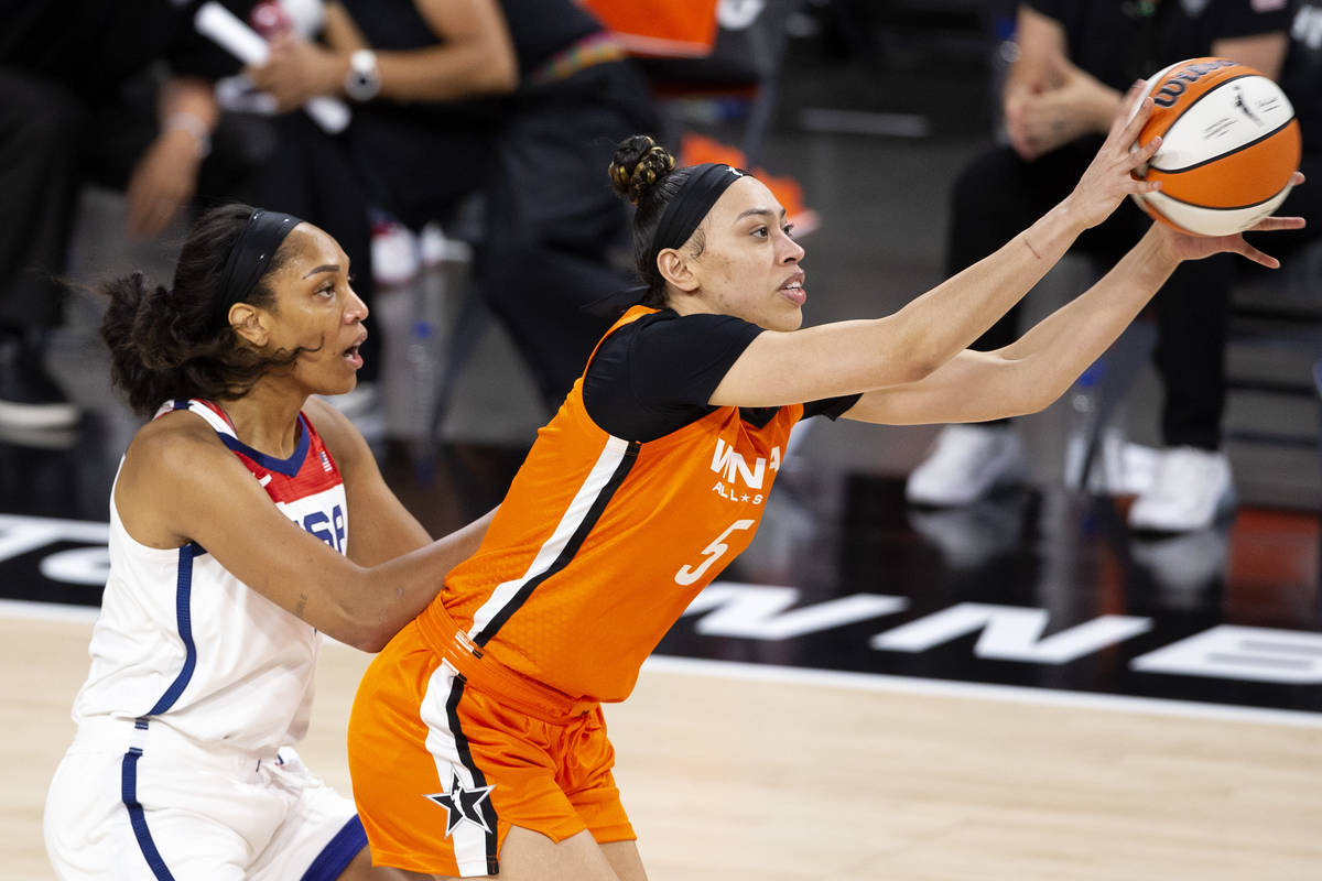 U.S. Women's National Team's A'ja Wilson, left, guards Team WNBA's Dearica Hamby while she catc ...