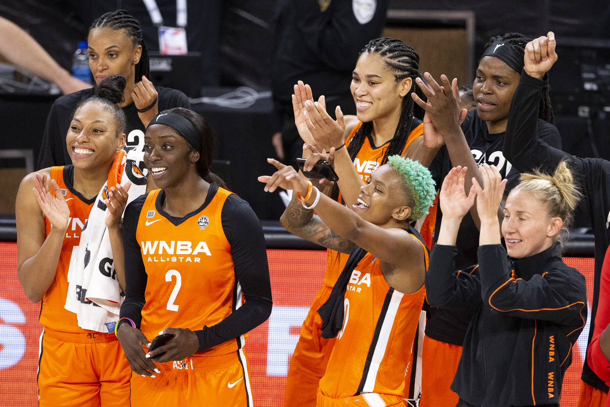 Members of Team WNBA cheer for teammate Arike Ogunbowale as she wins the MVP trophy during a WN ...