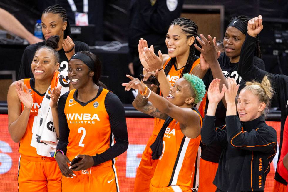 Members of Team WNBA cheer for teammate Arike Ogunbowale as she wins the MVP trophy during a WN ...