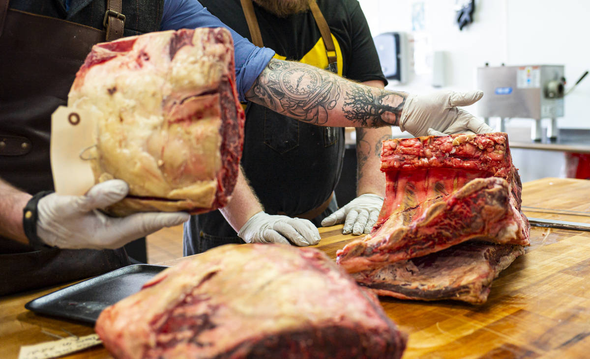 Martin Kirrane, owner and butcher at Featherblade Craft Butchery, left, works with apprentice J ...