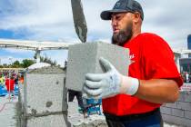 Gerardo Patlan of Phoenix, Arizona, stacks a concrete block in the Fastest Trowel on the Block ...