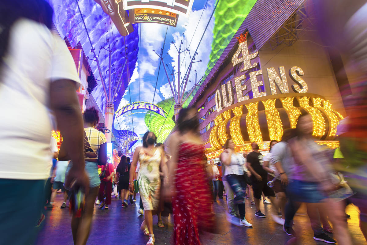 Visitors take in the sights at the Fremont Street Experience during Memorial Day weekend on Sat ...