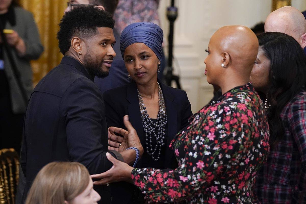 Usher speaks with Rep. Ilhan Omar, D-Minn., second from left, and Rep. Ayanna Pressley, D-Mass. ...