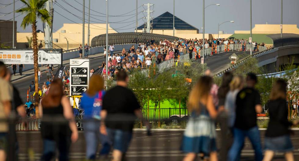 Fans make their way in the heat to the Garth Brooks concert at Allegiant Stadium on Friday, Jul ...