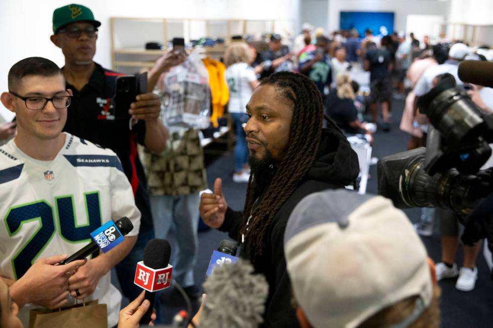 NFL running back Marshawn Lynch speaks to media at the opening of his store, Beast Mode, in The ...