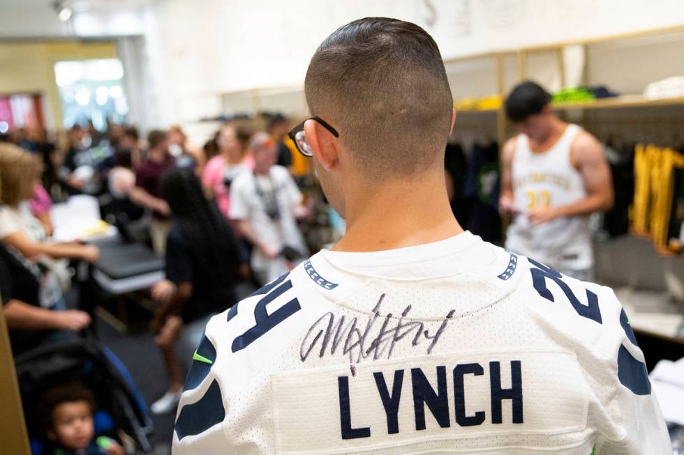 Esteban Soto, of Las Vegas, shows off his autographed Marshawn Lynch jersey at the opening of t ...