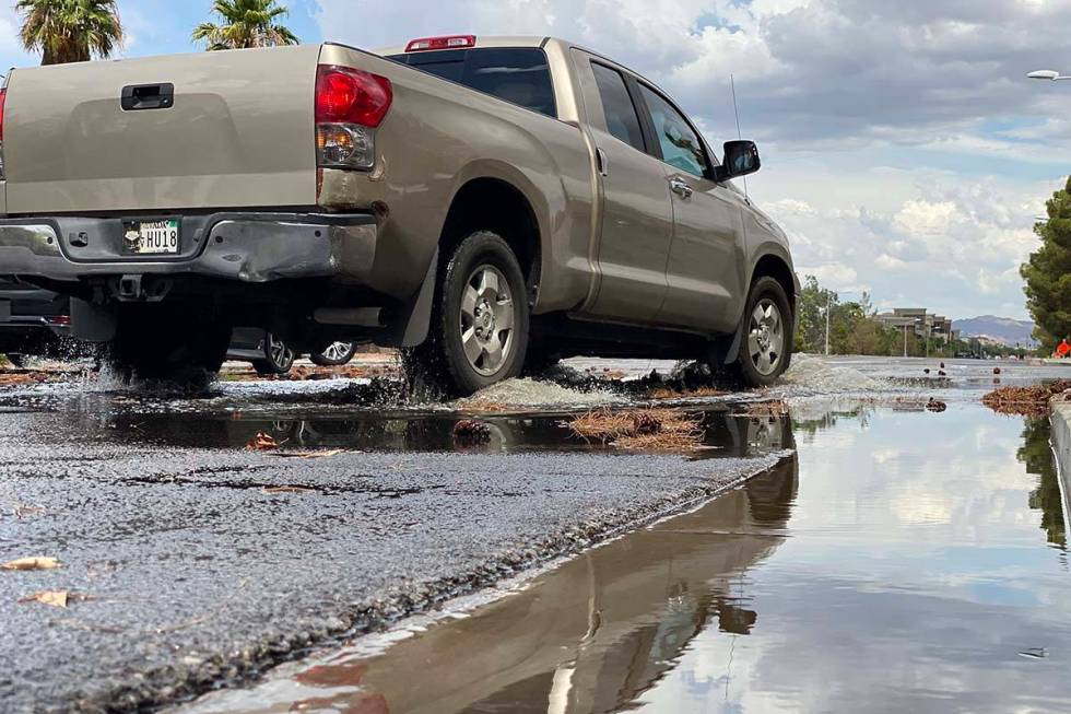 Drivers navigate through the rains Sunday, July 18, 2021, near Green Valley and Paseo Verde par ...