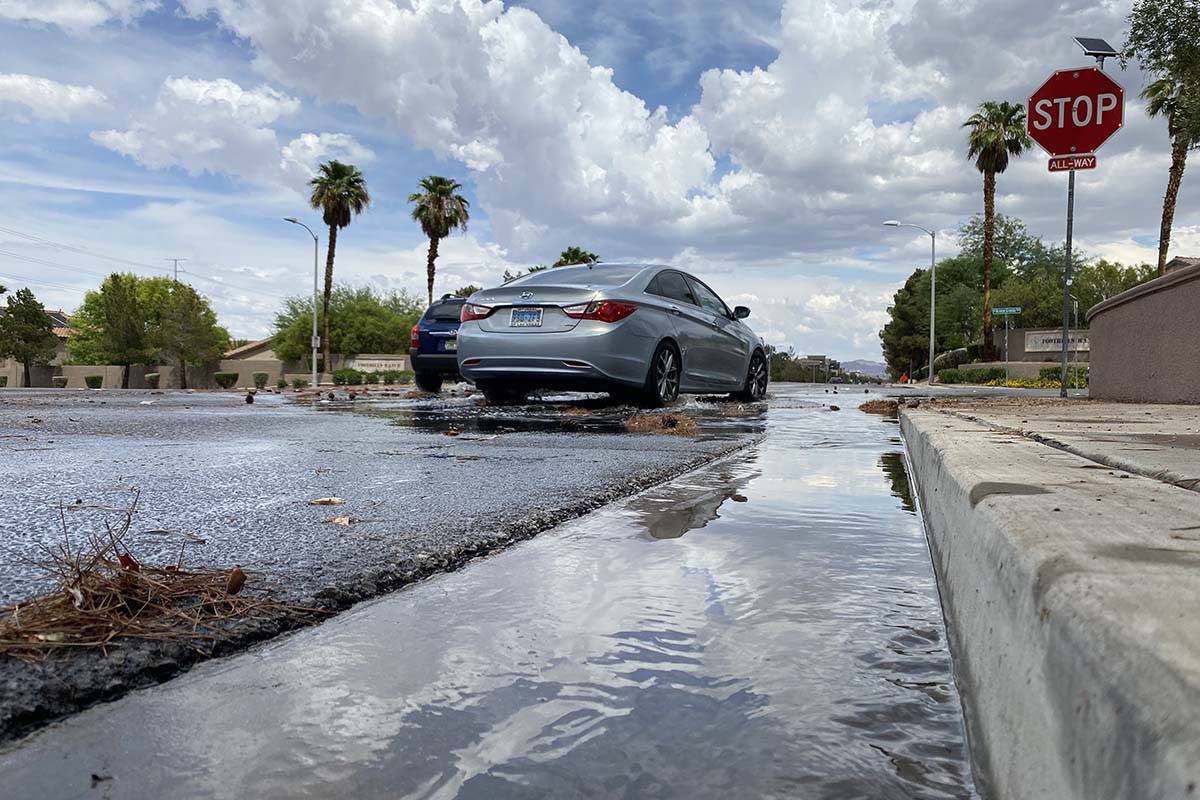 Drivers navigate through the rains Sunday, July 18, 2021, near Green Valley and Paseo Verde par ...