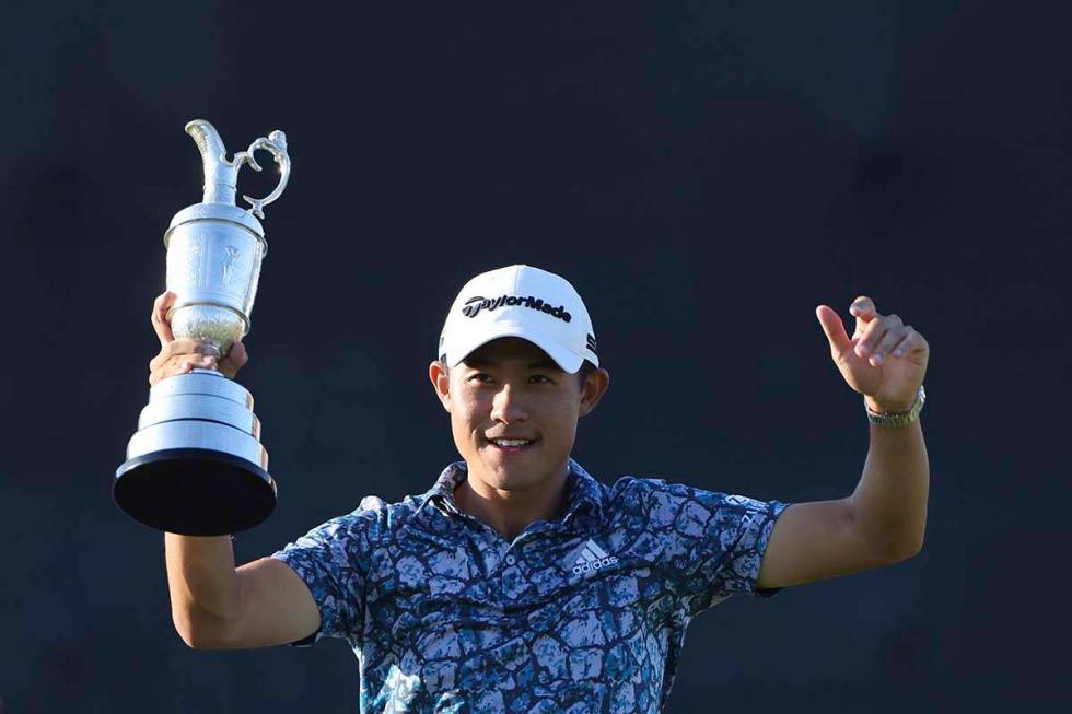 United States' Collin Morikawa holds up the claret jug trophy as he poses for photographers on ...