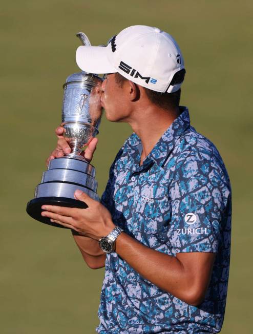 United States' Collin Morikawa kisses the claret jug trophy as he poses for photographers on th ...