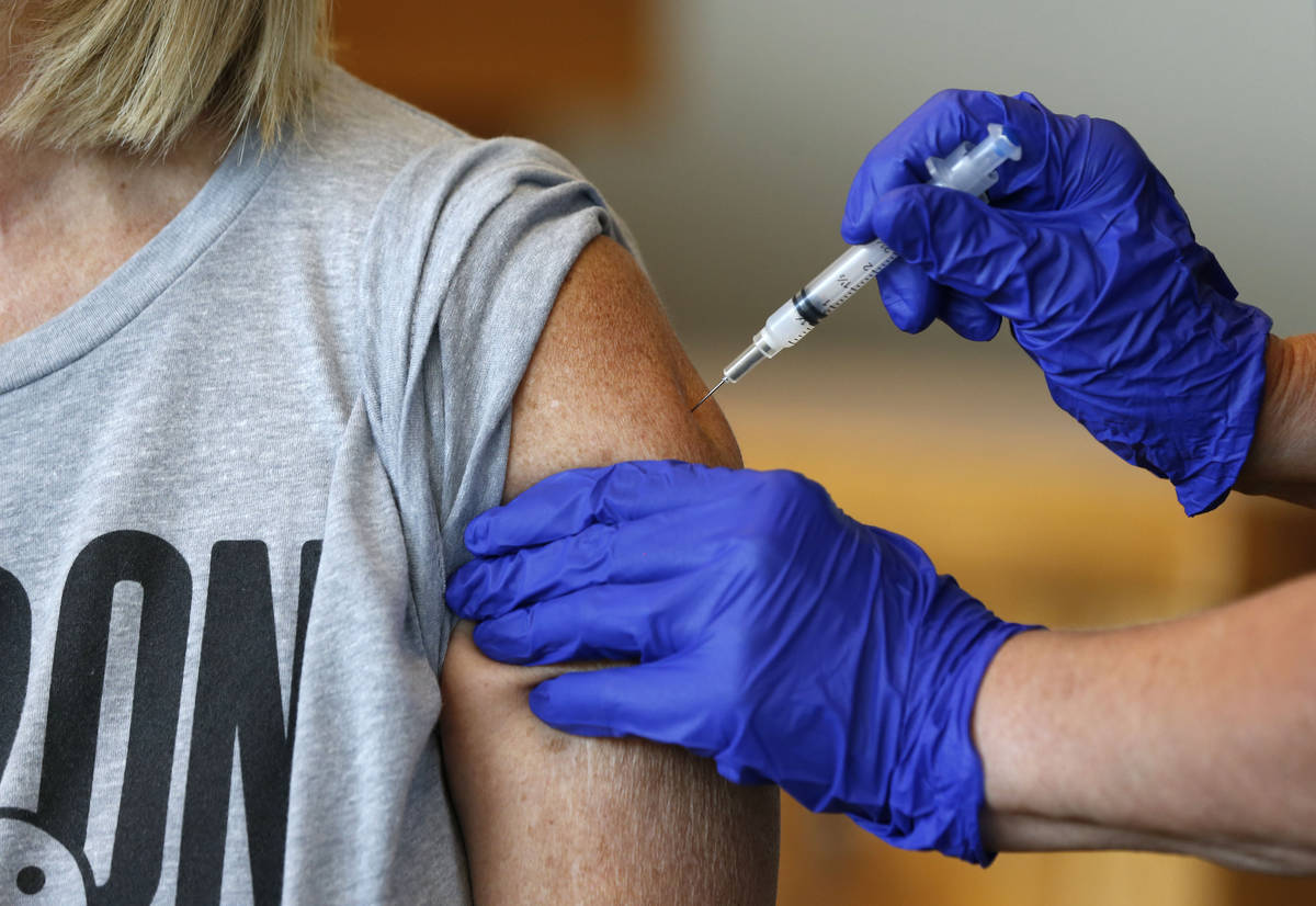 FILE - In this Monday, July 12, 2021 file photo, Karen Martin receives a COVID-19 vaccine at a ...