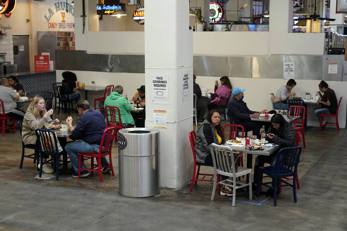 FILE - In this March 17, 2021 file photo Patrons eat lunch in an indoor space at Grand Central ...