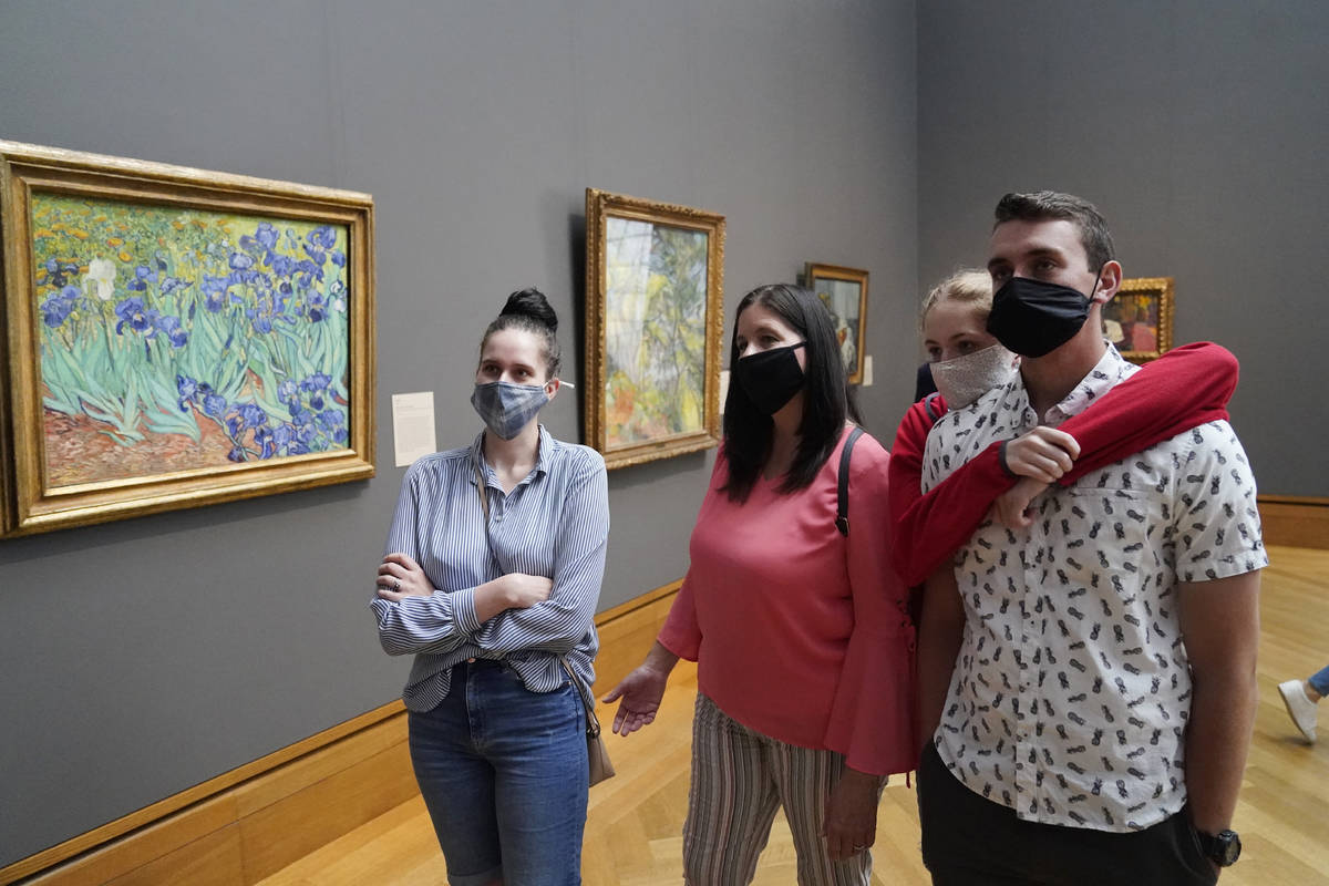 FILE - In this Wednesday, May 26, 2021 file photo, visitors wear masks as they view art, includ ...