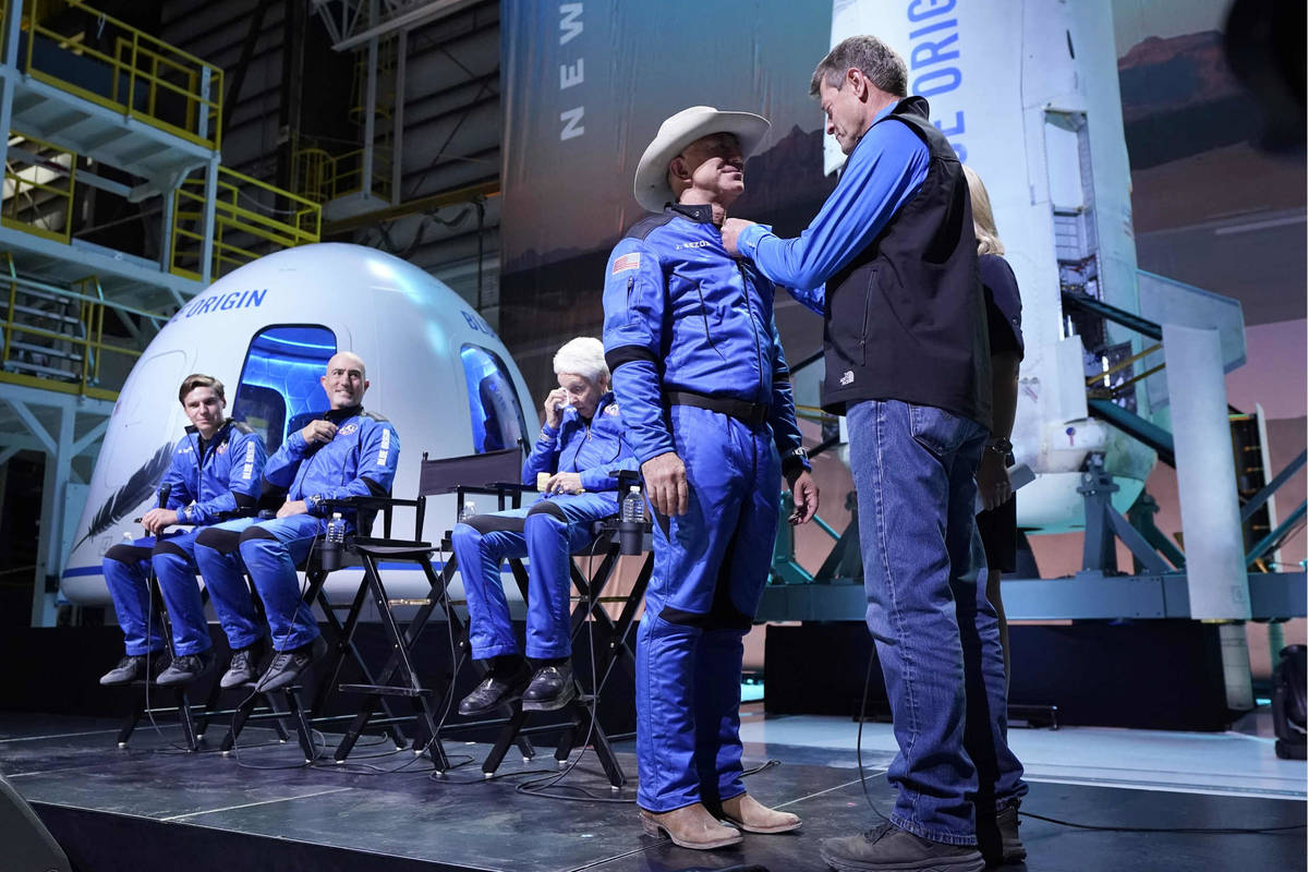 Oliver Daemen, from left, Mark Bezos and Wally Funk, look on as Jeff Bezos, second from right, ...