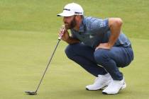 United States' Dustin Johnson looks along the line of his putt on the 6th green during the firs ...