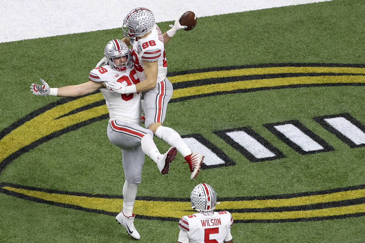 Ohio State tight end Luke Farrell celebrates after scoring with tight end Jeremy Ruckert during ...