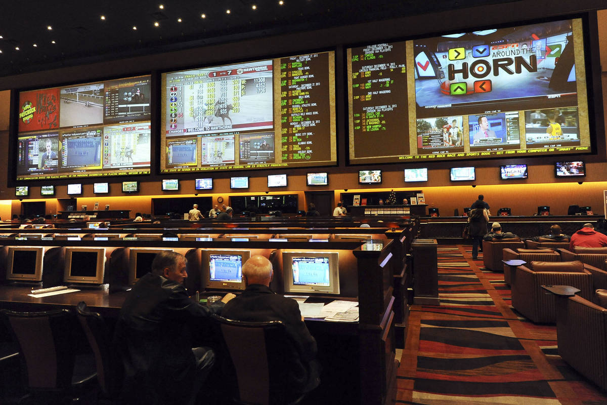 The Red Rock Resort hotel-casino Sports and Race Book displays the odds for the upcoming colleg ...