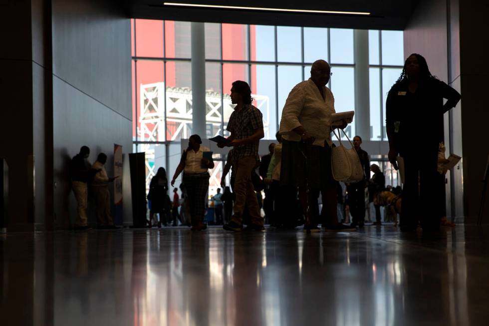 People enter the Las Vegas Convention Center for a summer job fair hosted by Clark County on Fr ...