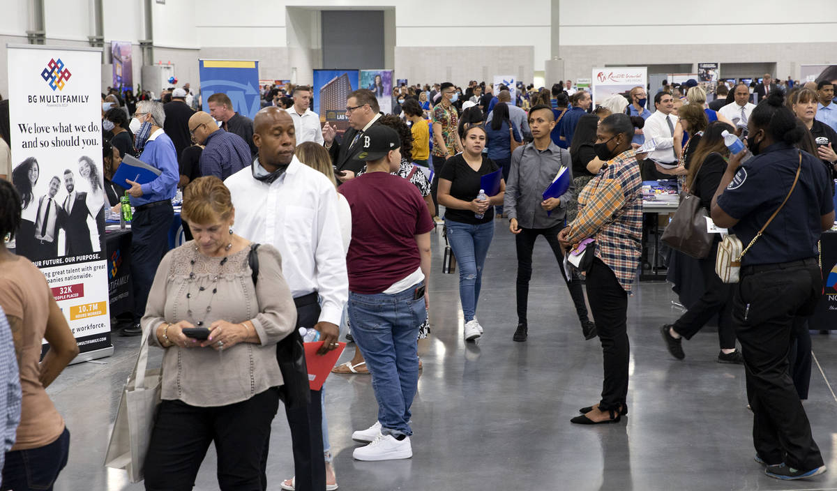 Job-seekers visit booths during a summer job fair hosted by Clark County, where 14,000 position ...