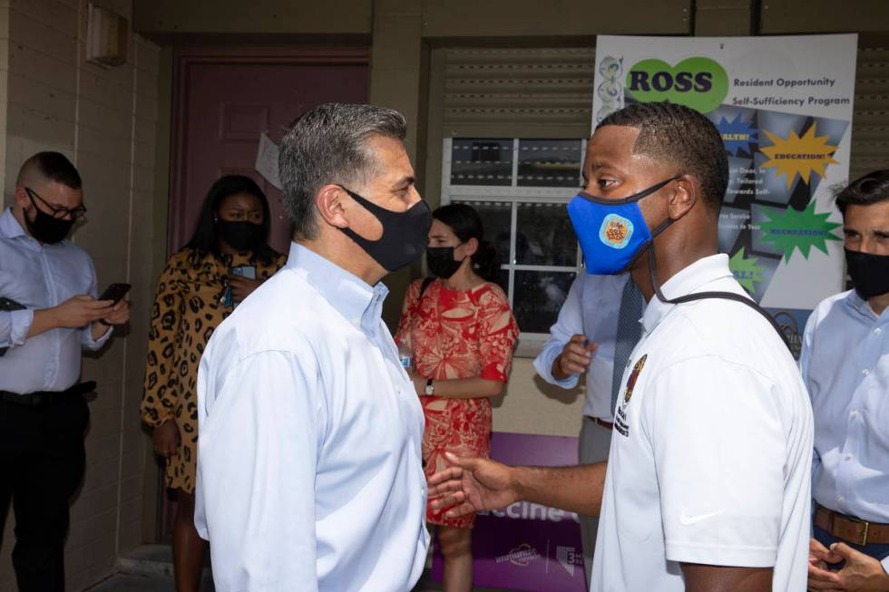 Health and Human Services Secretary Xavier Becerra, left, and Clark County Commissioner William ...