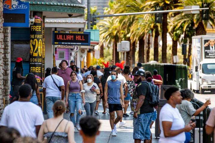 People walk along the Strip near The Venetian, most not wearing masks anymore on Friday, July 1 ...