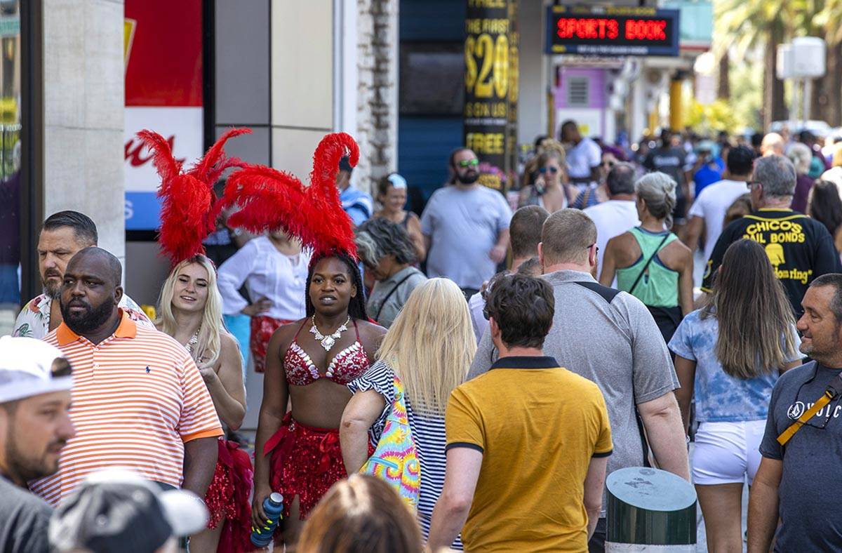 People walk along the Strip near The Venetian, most not wearing masks anymore on Friday, July 1 ...