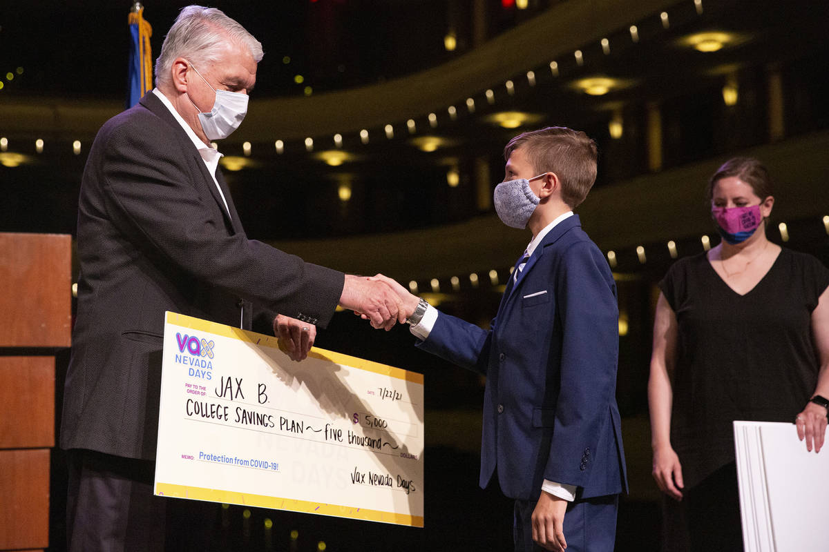 Gov. Steve Sisolak shakes Jax B.'s hand after he won a $5,000 college savings plan in the third ...
