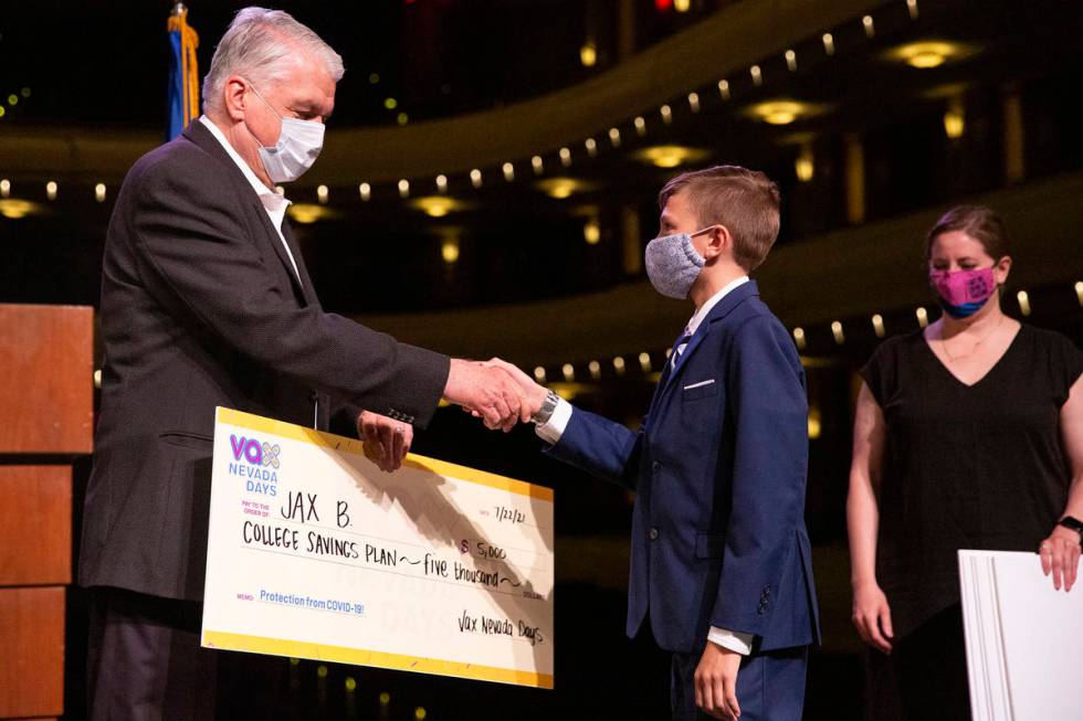 Gov. Steve Sisolak shakes Jax B.'s hand after he won a $5,000 college savings plan in the third ...